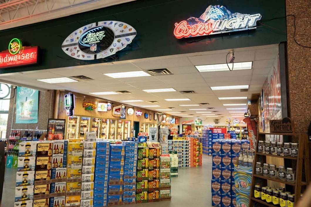 A grocery store with a sign that says budweiser on it