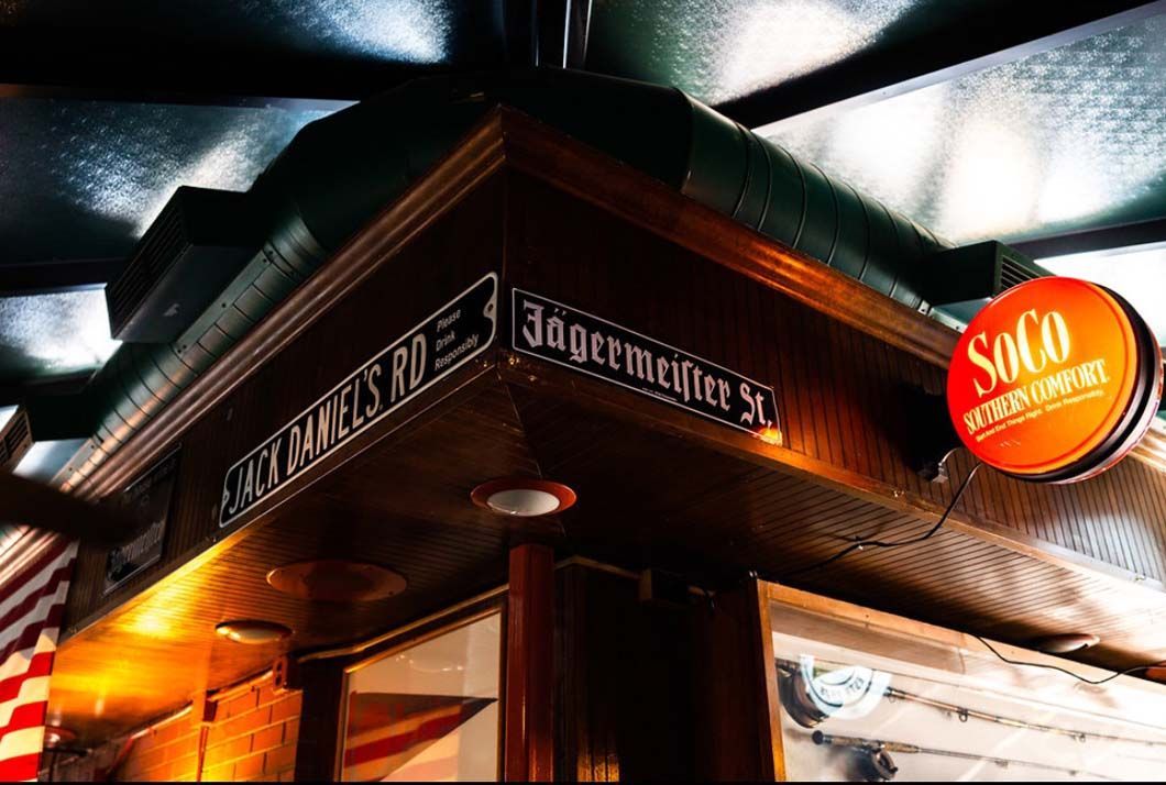 A corner of a building with a sign that says soco