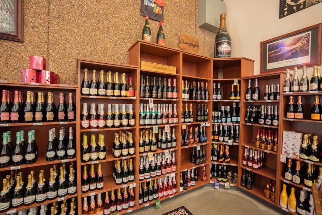 A store filled with lots of bottles of beer on shelves.