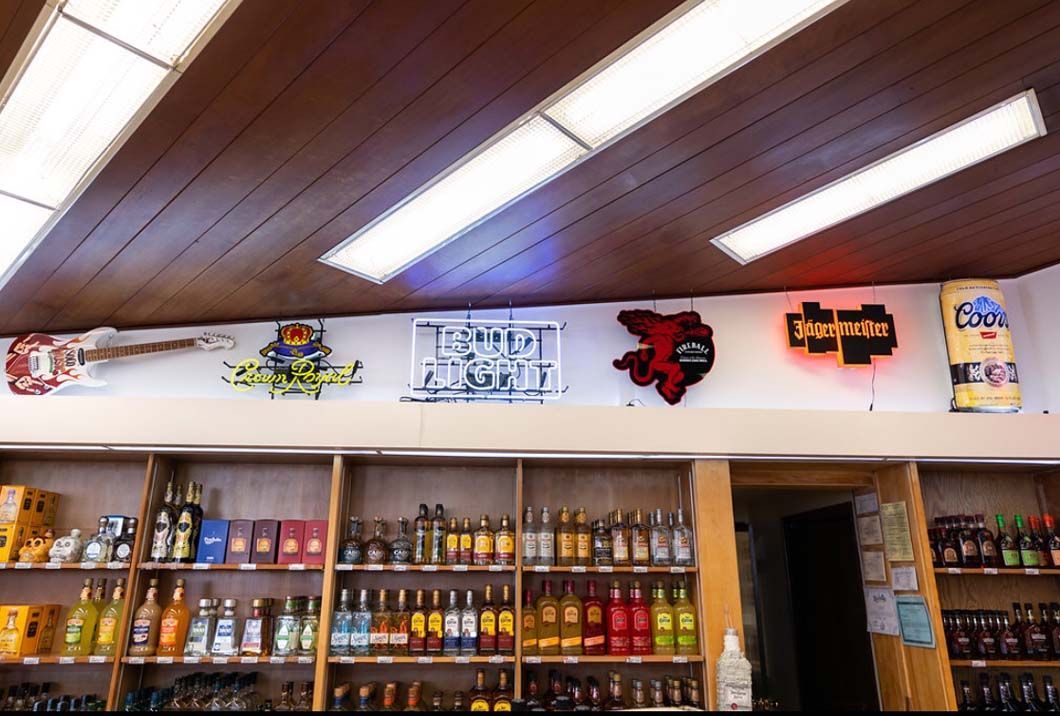 A liquor store with lots of bottles of alcohol on shelves