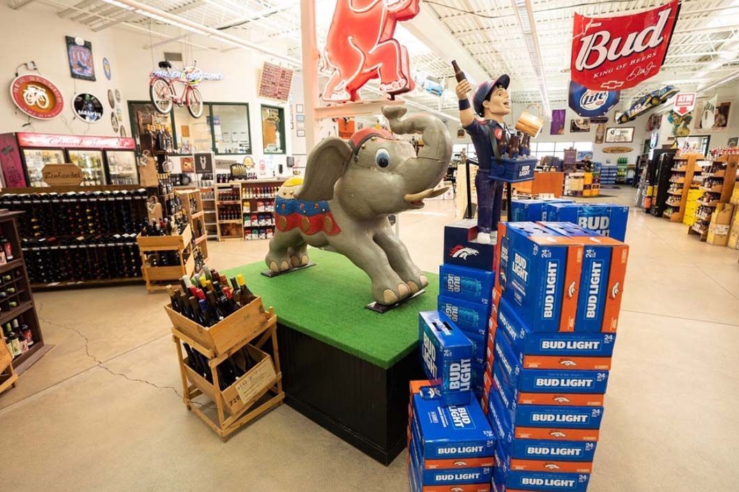 An elephant statue is sitting on top of a table in a store.