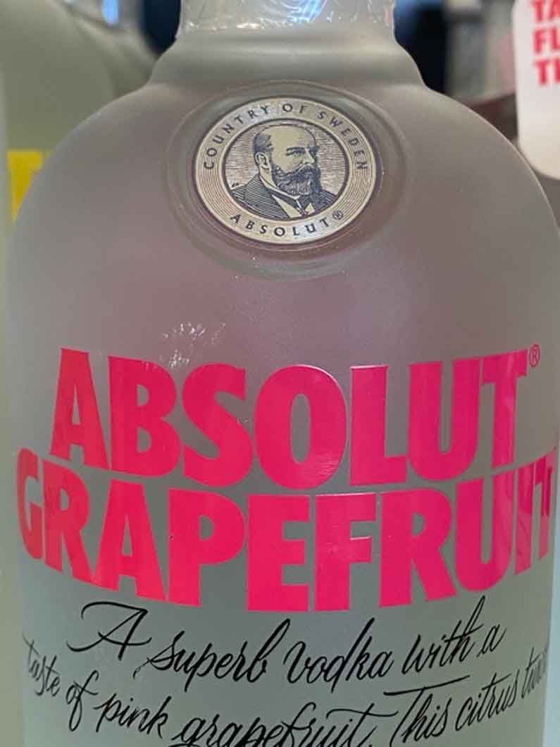 A close up of a bottle of absolut grapefruit vodka