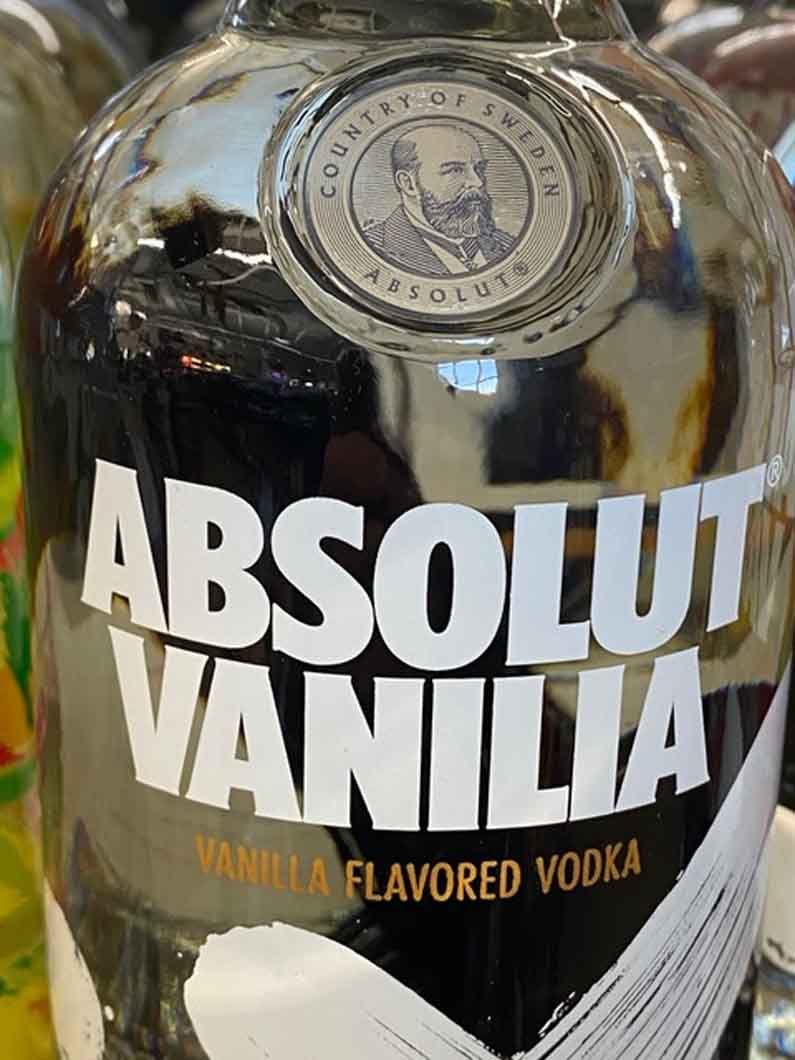 A bottle of absolut vanilla vodka is sitting on a table.
