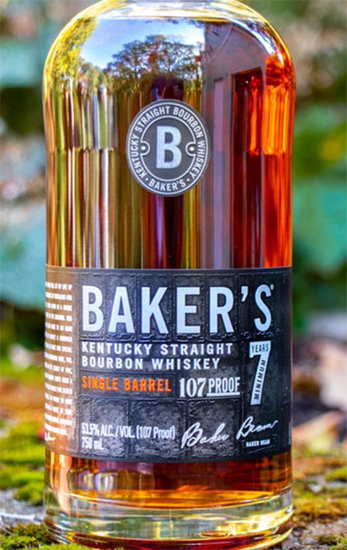 A bottle of baker 's kentucky straight bourbon whiskey is sitting on a rock.
