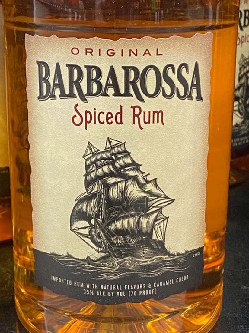 A bottle of barbarossa spiced rum is sitting on a table.