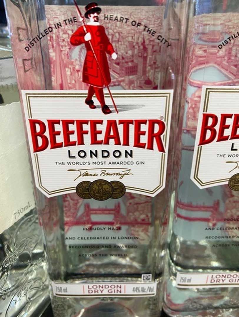 A bottle of beefeater london gin is sitting on a table.