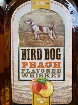A bottle of bird dog peach flavored whiskey