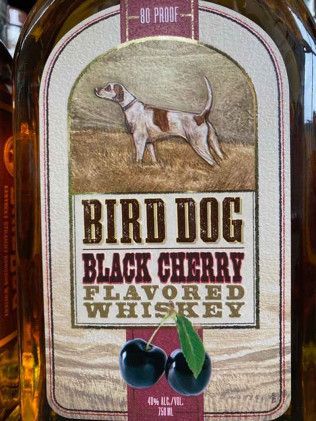 A bottle of bird dog black cherry flavored whiskey