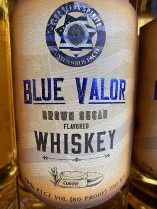 A bottle of blue valor brown sugar flavored whiskey