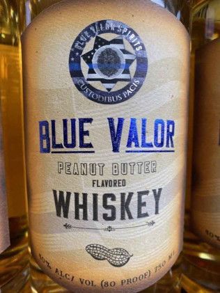 A bottle of blue valor peanut butter flavored whiskey