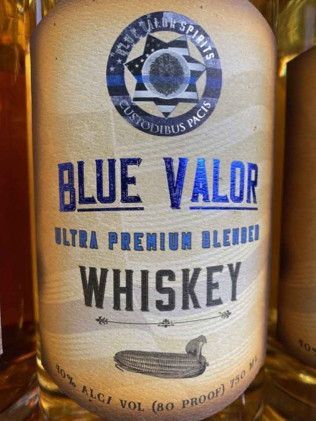 A close up of a bottle of blue valor whiskey