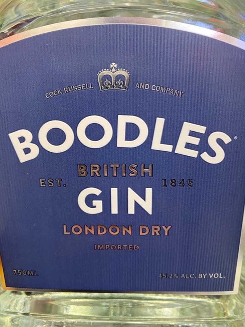 A bottle of boodles british gin london dry is sitting on a table.