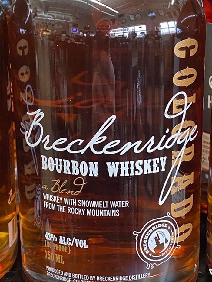 A bottle of breckenridge bourbon whiskey is sitting on a shelf.
