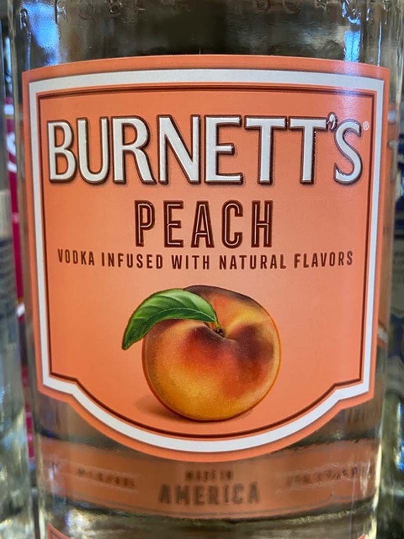 A bottle of burnett 's peach vodka infused with natural flavors