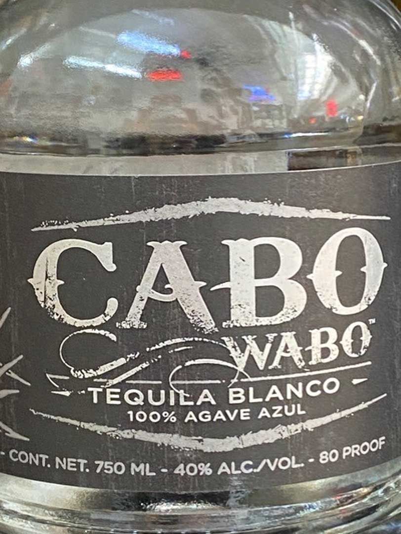 A close up of a bottle of cabo wabo tequila blanco.