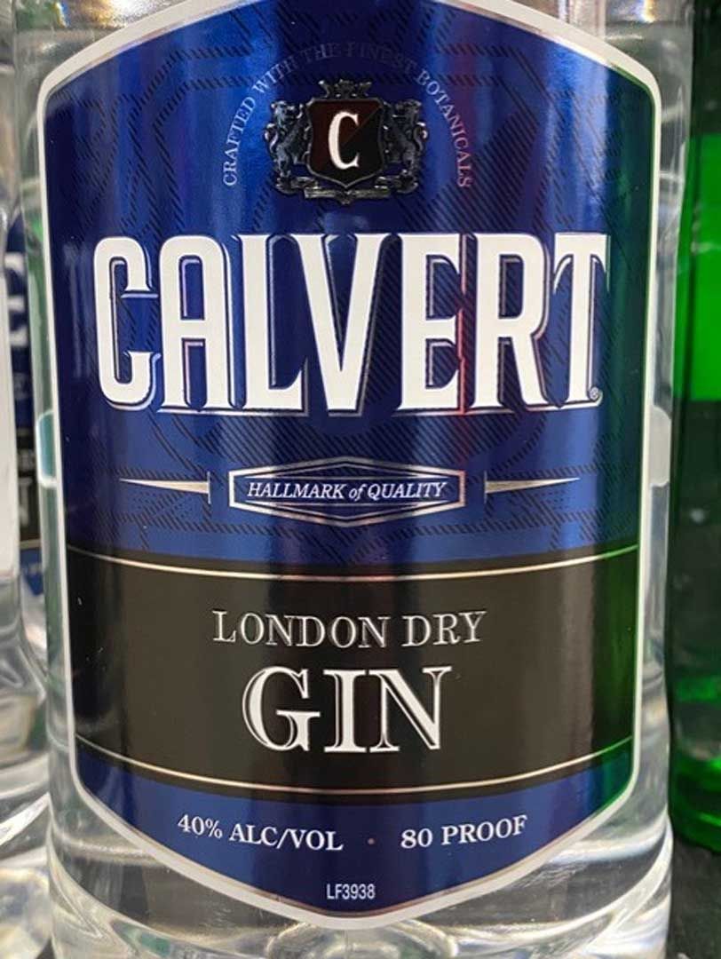 A bottle of calvert london dry gin is sitting on a table.
