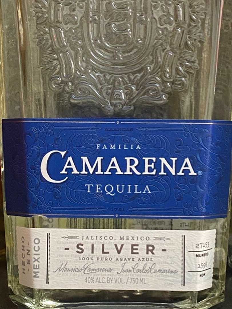 A bottle of camarena silver tequila is sitting on a table.