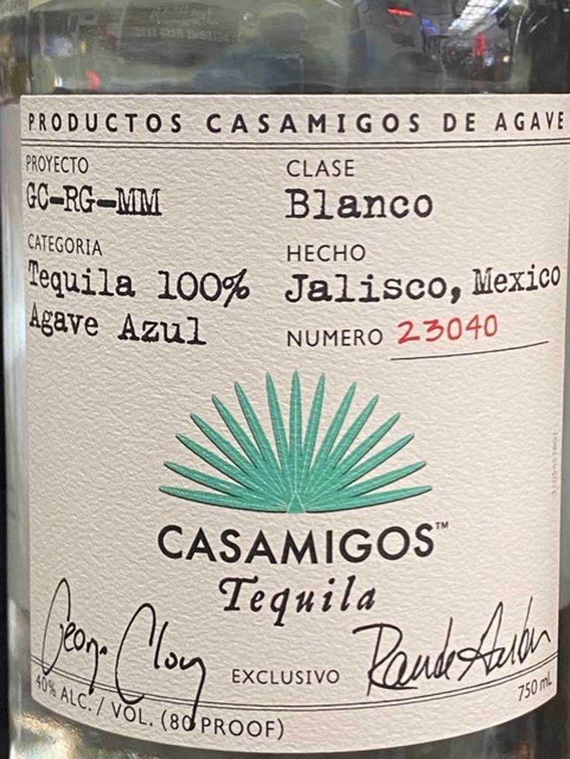 A bottle of casamigos tequila is sitting on a table.