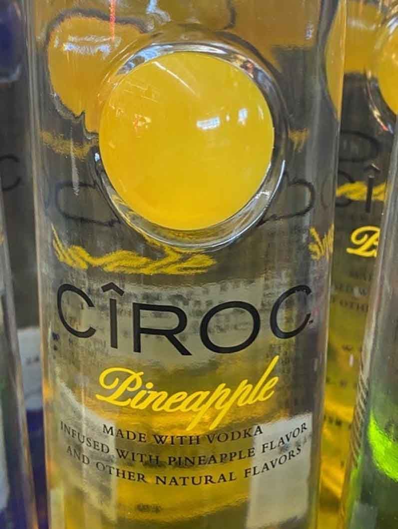 A close up of a bottle of ciroc pineapple vodka.