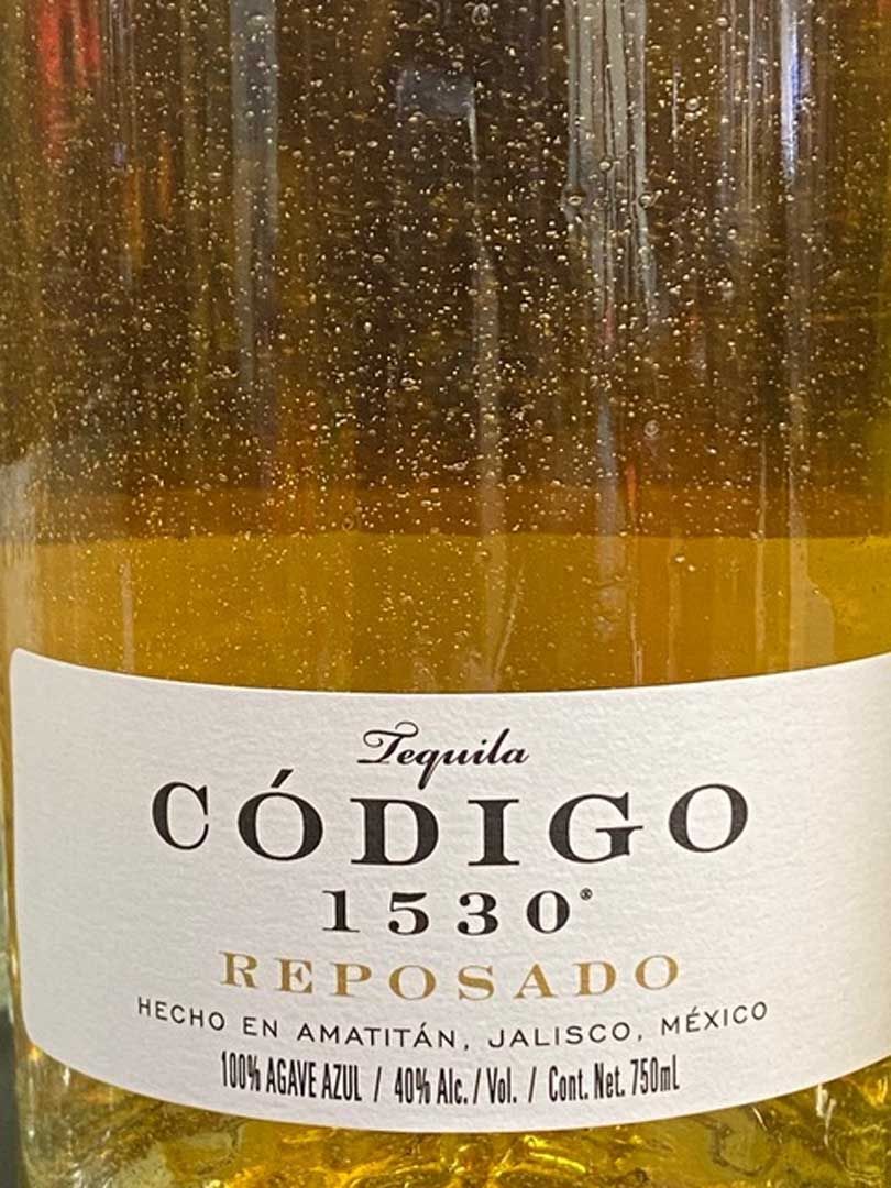 A close up of a bottle of tequila called codigo 1530 reposado.