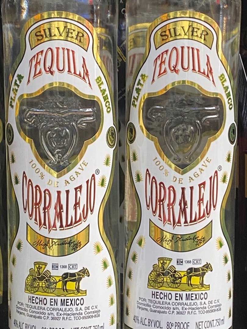 Two bottles of silver tequila are sitting next to each other on a table.