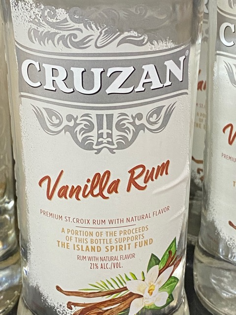 A bottle of cruzan vanilla rum is sitting on a table.