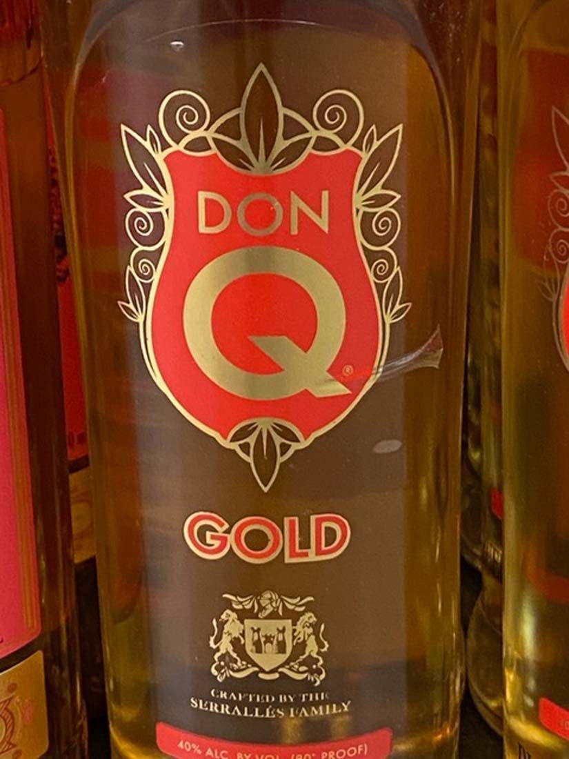 A bottle of don q gold sits on a table