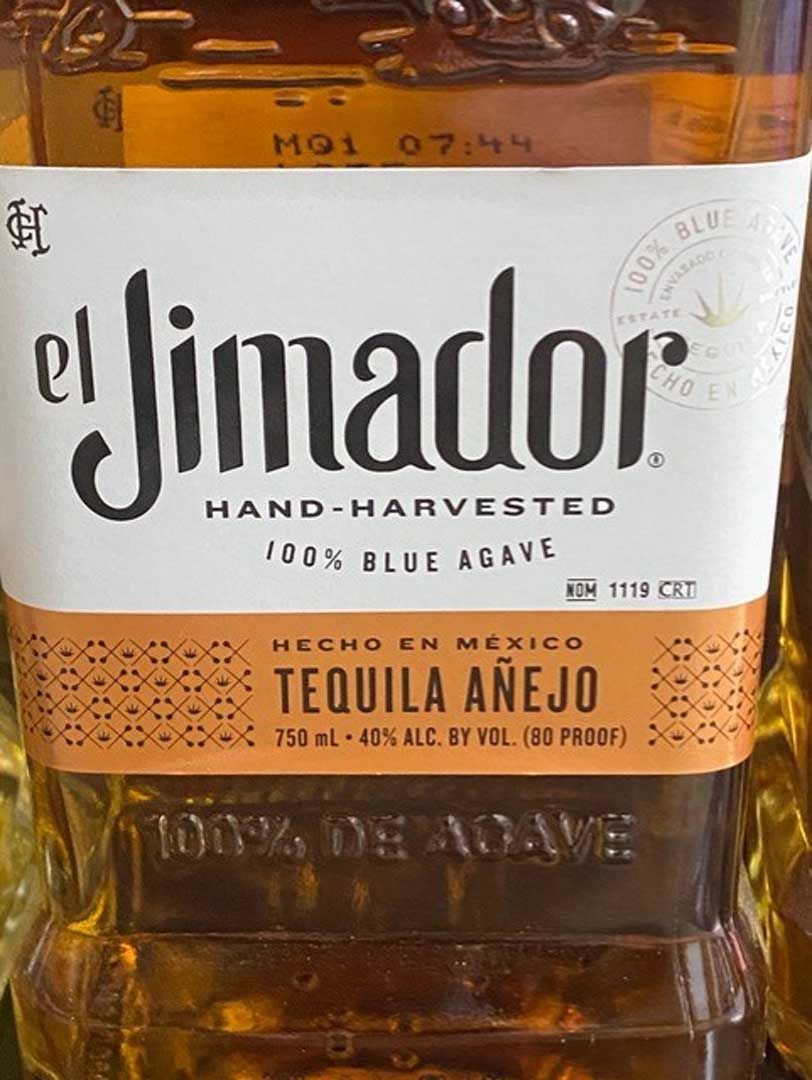 A bottle of el jimador hand harvested tequila añejo