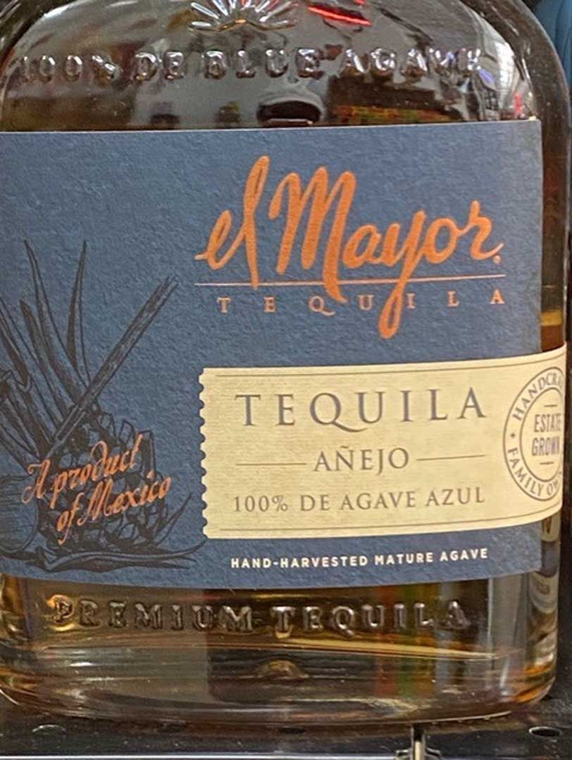 A bottle of el mayor tequila añejo 100 % de agave azul