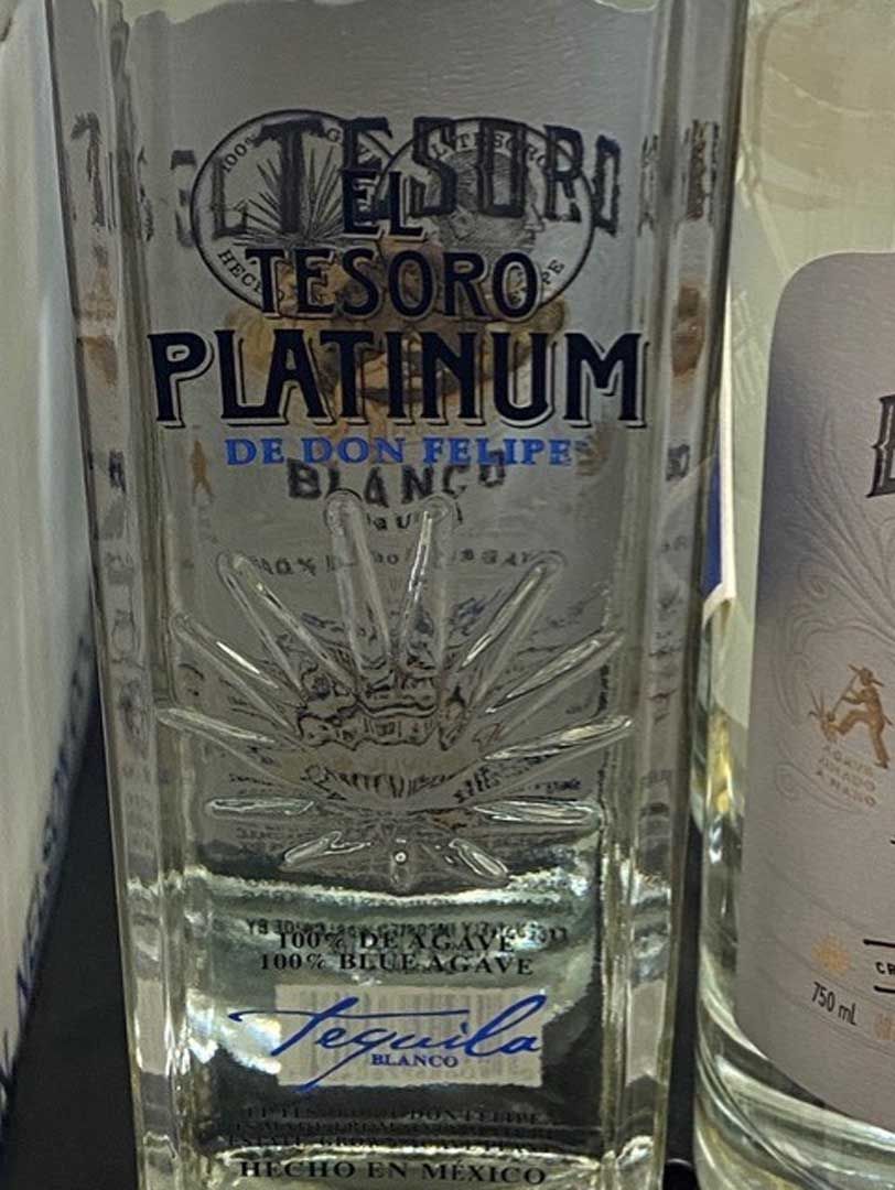 A close up of a bottle of tequila on a table.