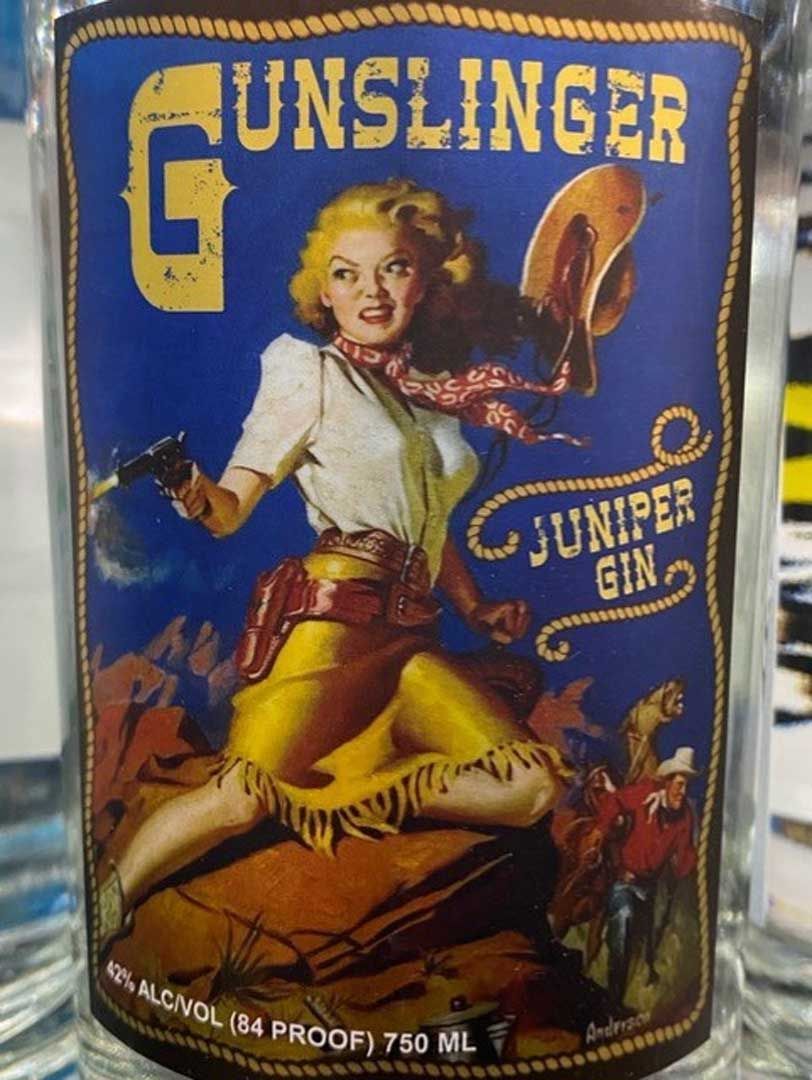 A bottle of gunslinger juniper gin with a woman on the label