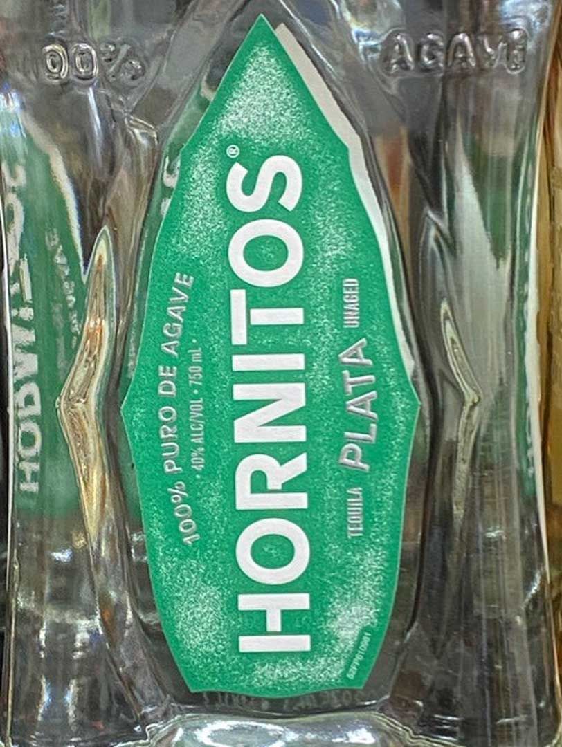 A bottle of hornitos tequila with a green label