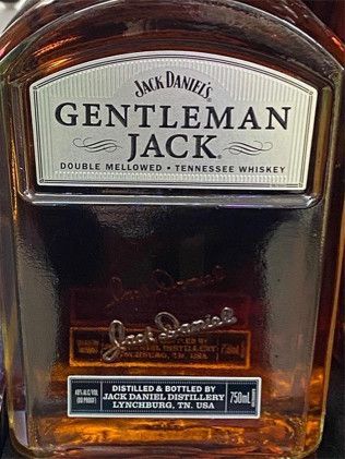 A bottle of jack daniel 's gentleman jack is sitting on a table.