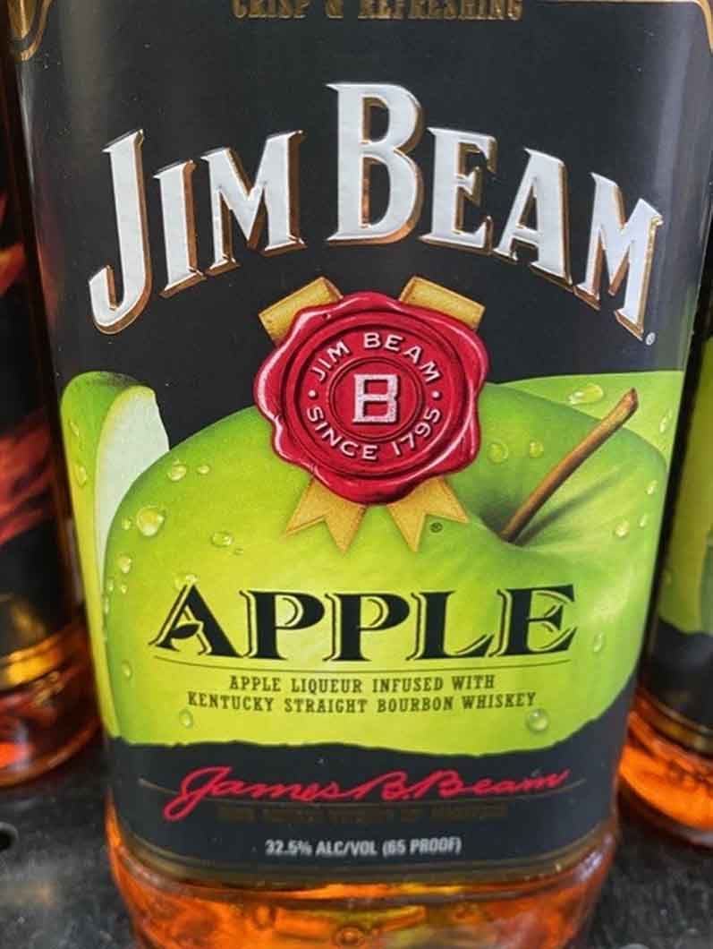 A bottle of jim beam apple sitting on a table