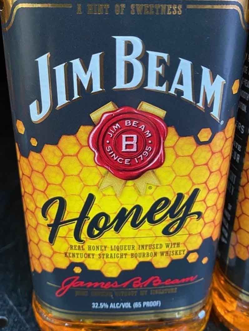 A close up of a bottle of jim beam honey