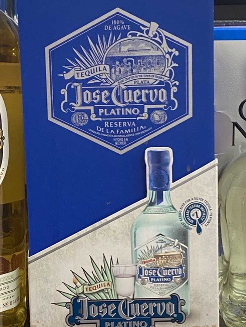 A box of jose cuervo tequila sits next to a bottle
