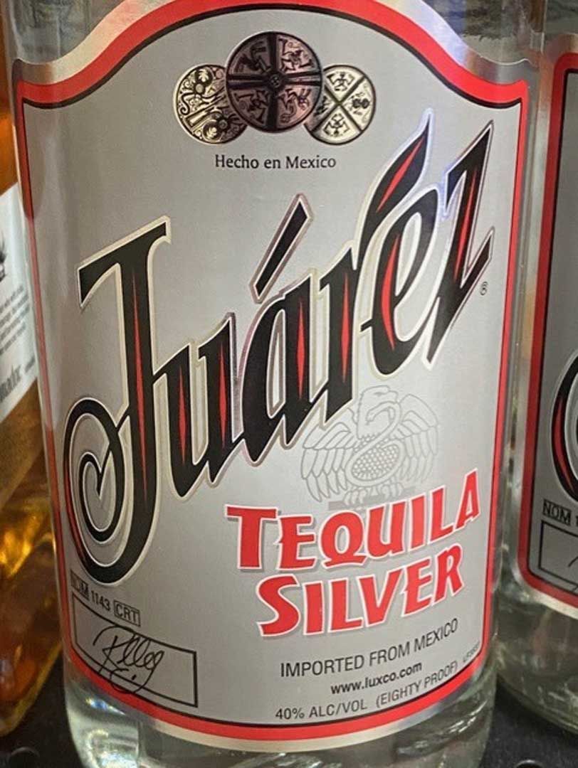 A close up of a bottle of juarez tequila silver