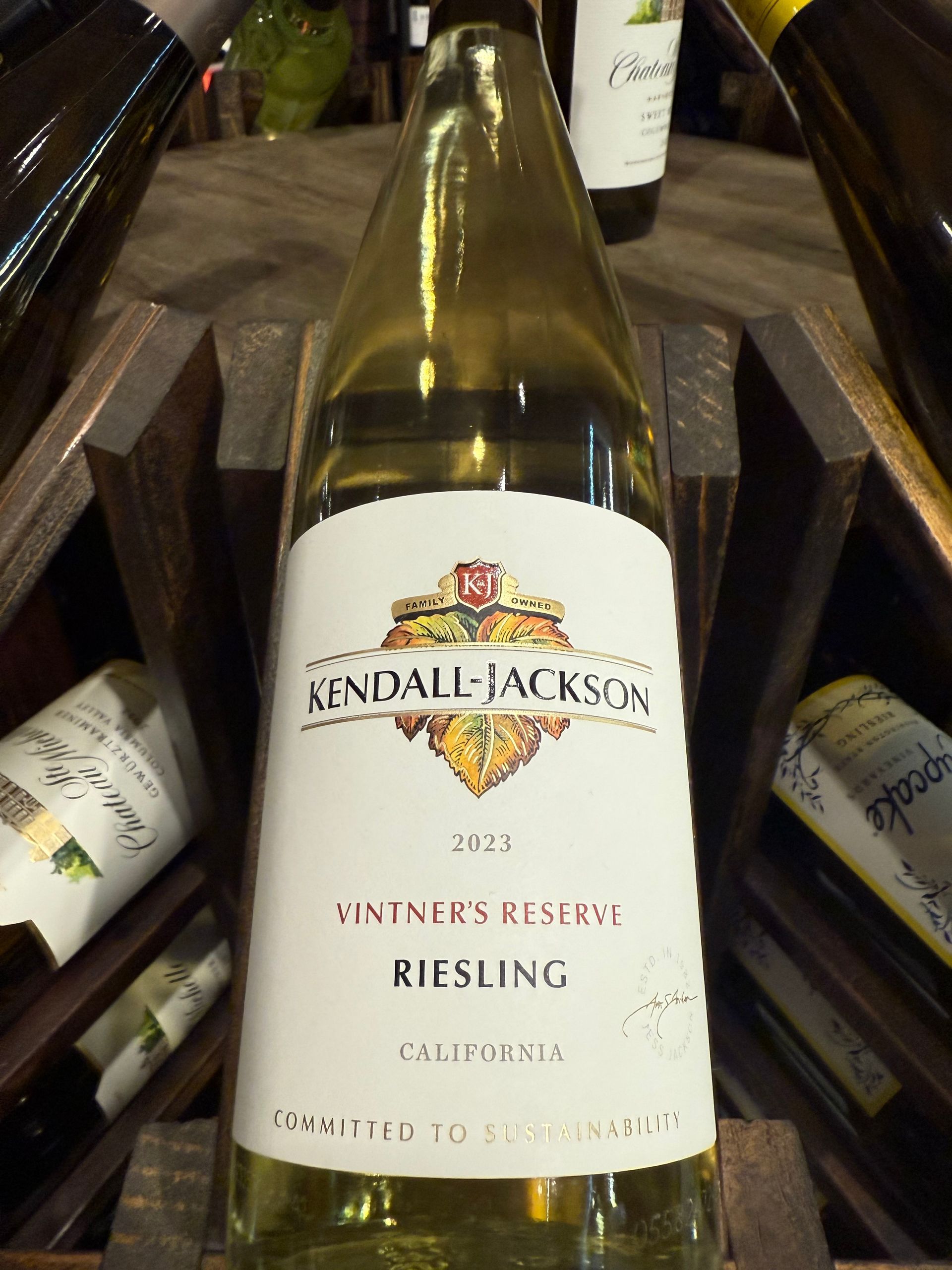 Kendall-Jackson Vintner's Reserve Riesling wine bottle in a wooden rack.