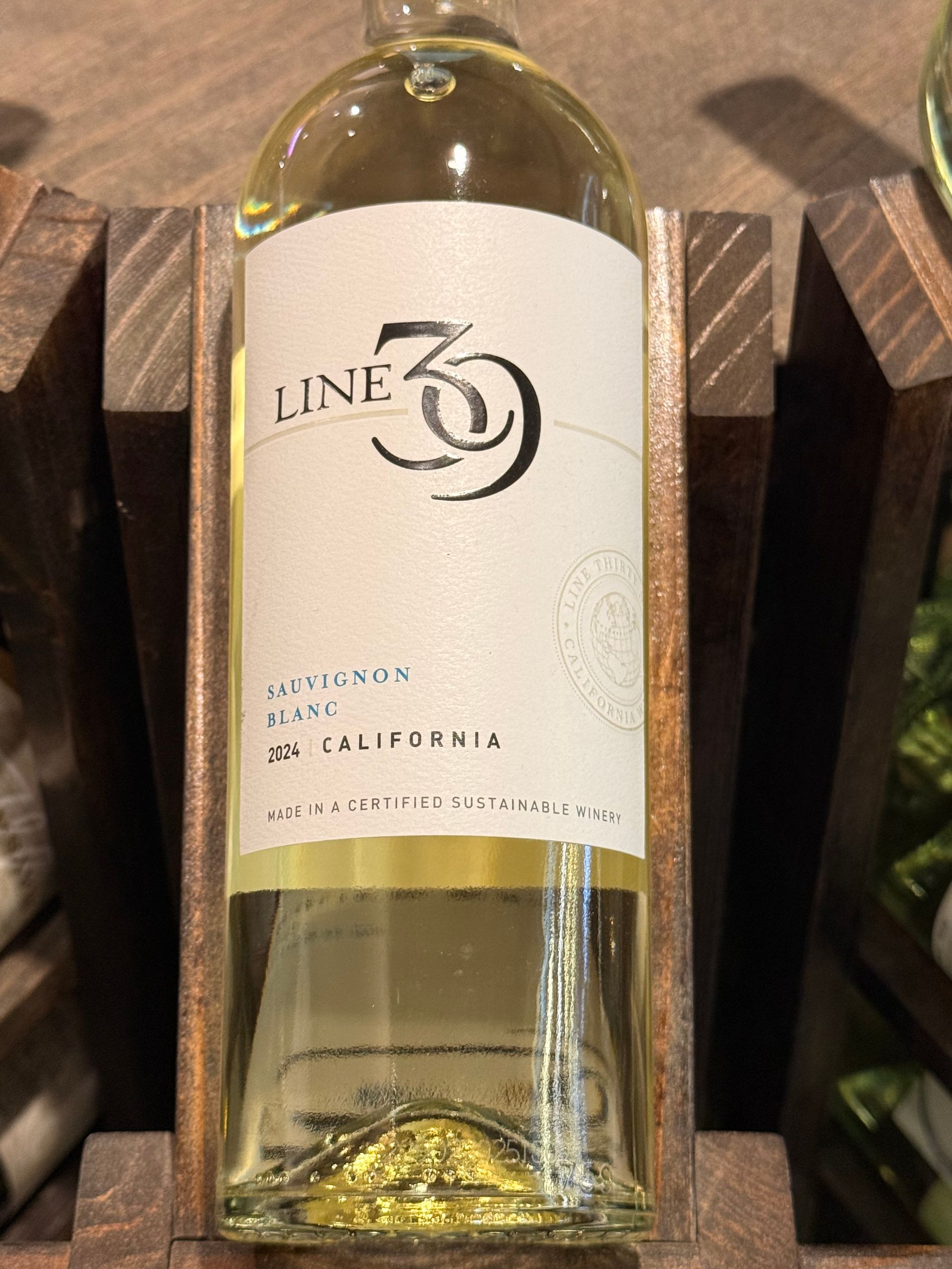 Bottle of Rutherford Ranch 2013 Chardonnay, Napa Valley. Beige label with red logo and text on a dark brown bottle.