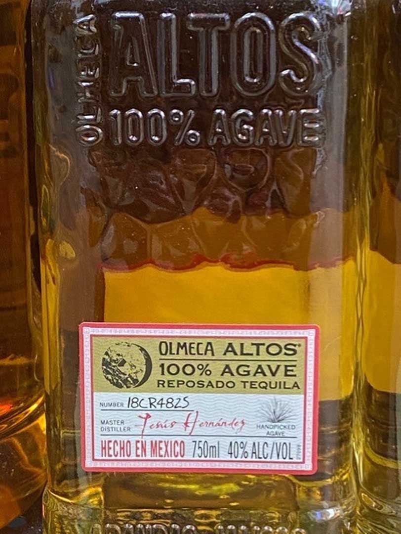 A close up of a bottle of tequila with a label on it.