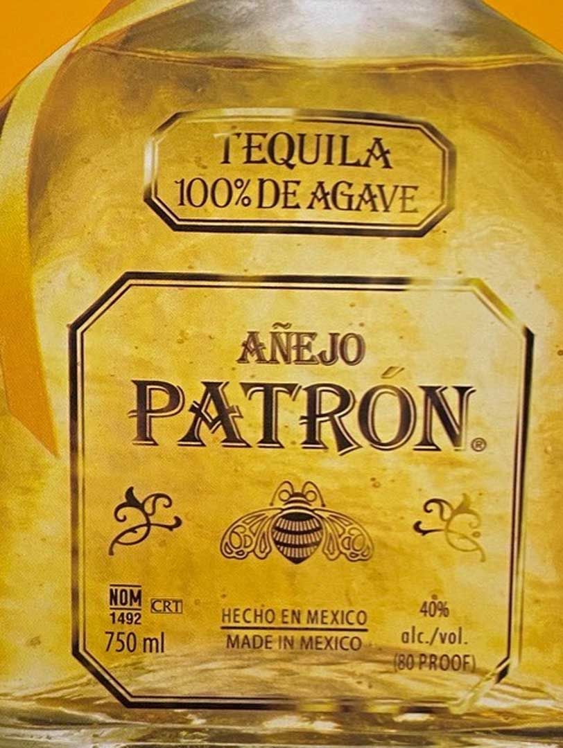 A close up of a bottle of patron tequila