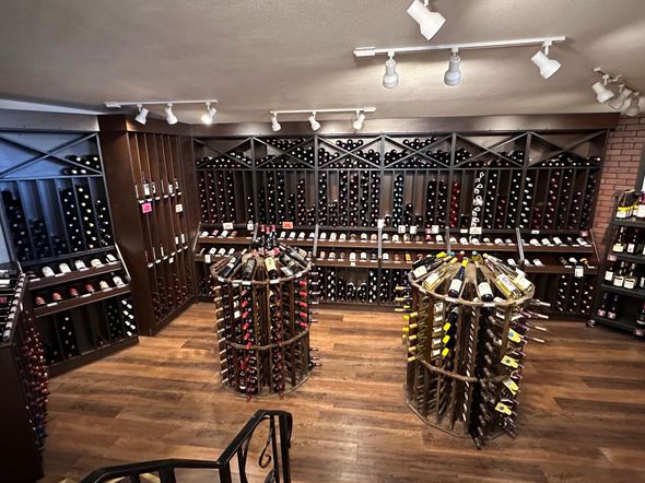 A large wine cellar filled with lots of bottles of wine.