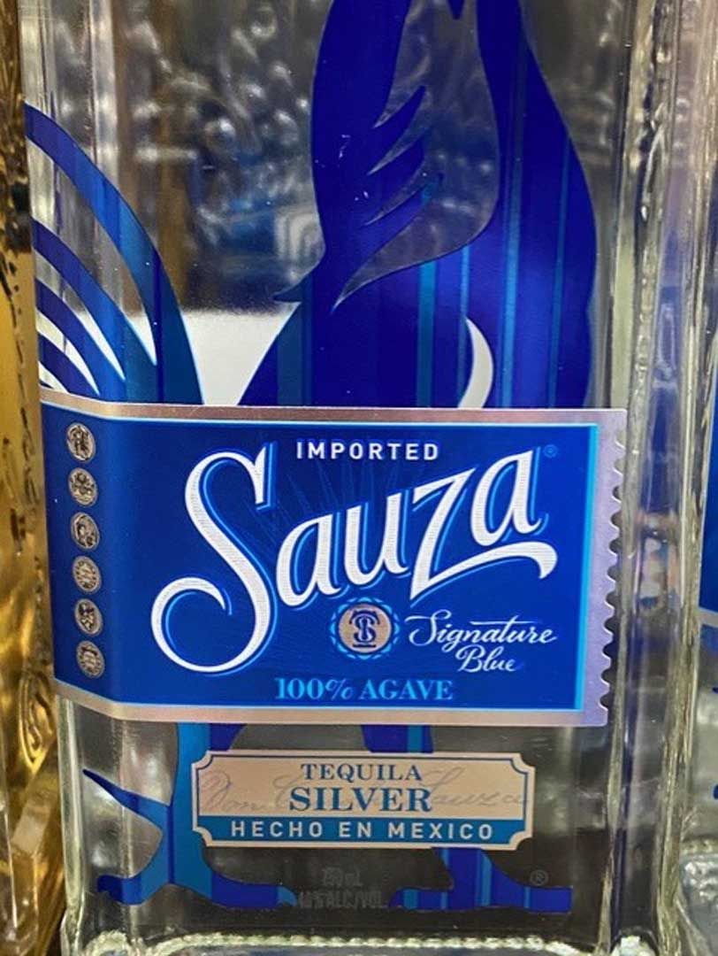 A bottle of sauza tequila is sitting on a table