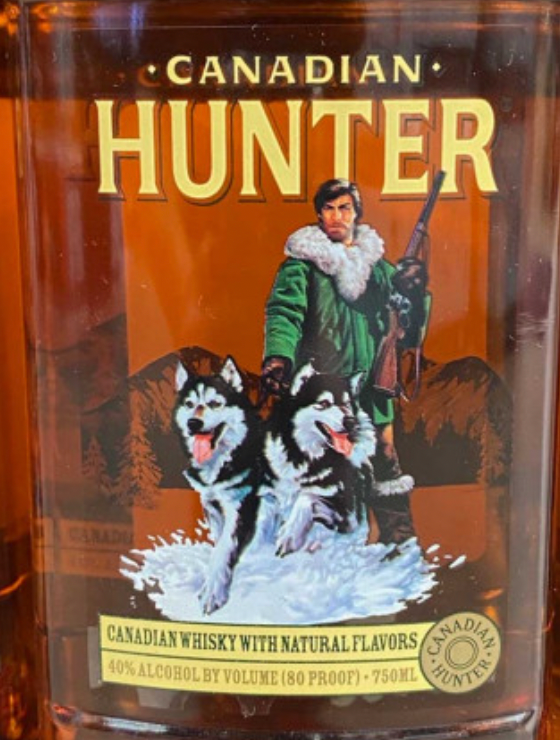 A bottle of canadian hunter whisky with two huskies on the label