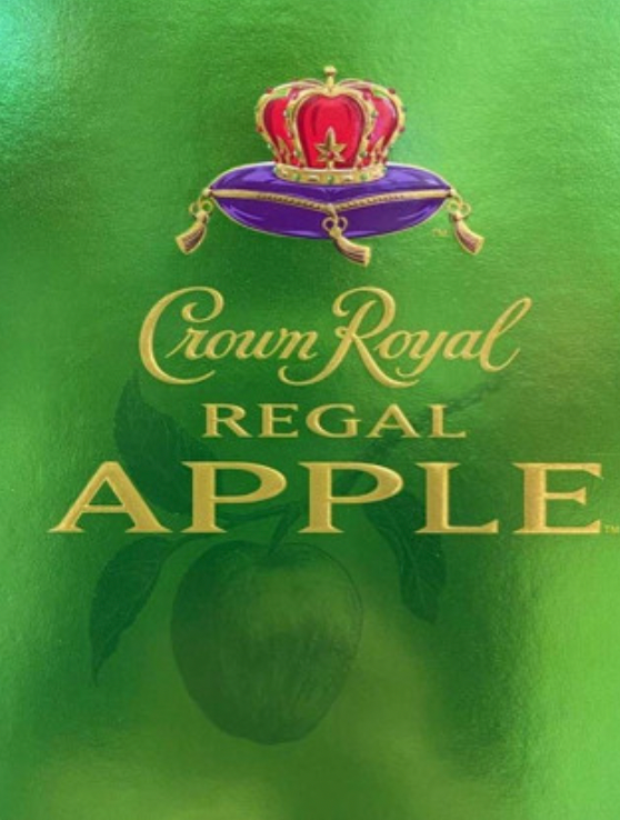 A bottle of crown royal regal apple on a green background