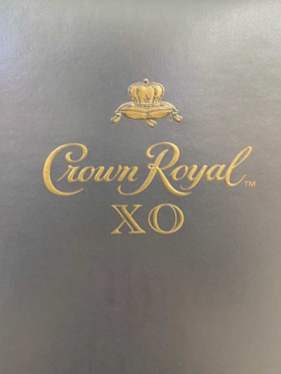 A bottle of crown royal xo sits on a table
