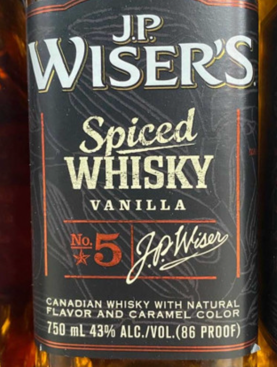A bottle of jp wiser 's spiced whisky vanilla