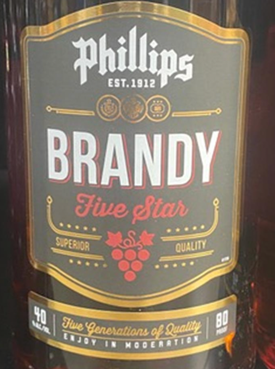 A bottle of phillips brandy sits on a table
