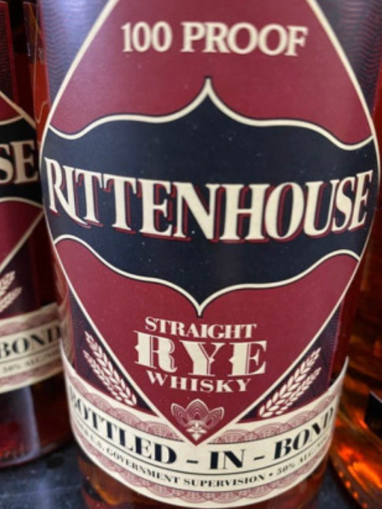 A close up of a bottle of rittenhouse straight rye whisky