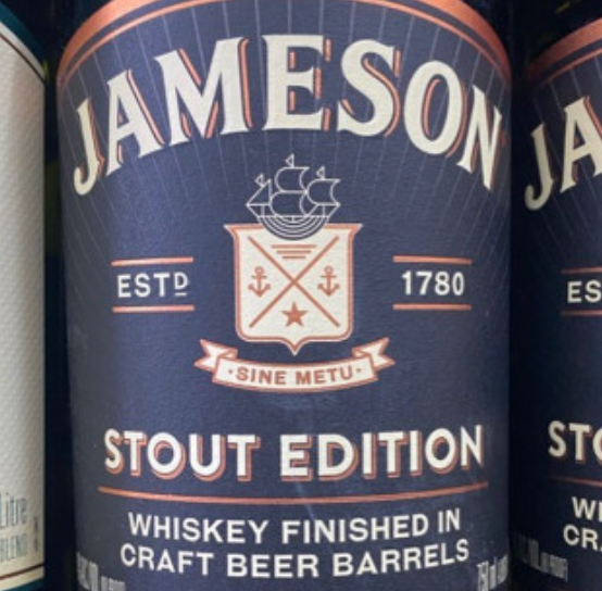 A bottle of jameson stout edition whiskey finished in craft beer barrels